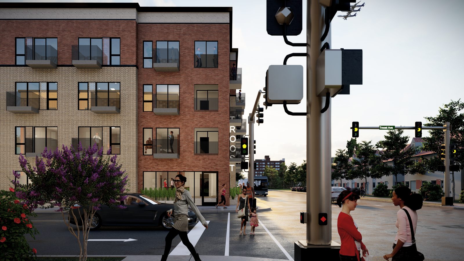 The same building from across Troost, with people crossing at the signal